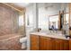 Bathroom with a large glass door shower, wood cabinets and views to another bedroom at 41503 N 109Th Pl, Scottsdale, AZ 85262
