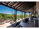 Outdoor patio features an outdoor kitchen, lounge seating, jacuzzi, dipping pool, and views of the desert landscape at 41503 N 109Th Pl, Scottsdale, AZ 85262