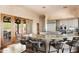 Well-lit kitchen features granite counters, center island with bar stool seating, and wooden-frame glass doors to an outdoor living space at 41503 N 109Th Pl, Scottsdale, AZ 85262