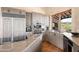 This well-appointed kitchen features granite counters, tiled floors, stainless appliances, wooden cabinets, recessed lighting and a window at 41503 N 109Th Pl, Scottsdale, AZ 85262
