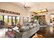 Spacious living room features a large sofa, high ceilings, wood floors, and mountain views through the windows at 41503 N 109Th Pl, Scottsdale, AZ 85262