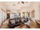 Open concept living area flows seamlessly from the living room to the kitchen and dining space with dark wood floors at 41503 N 109Th Pl, Scottsdale, AZ 85262
