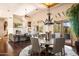 Open living area features a stone fireplace, french doors, and a formal dining area with a chandelier at 41503 N 109Th Pl, Scottsdale, AZ 85262