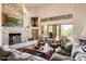 Cozy living room features a stone fireplace, comfortable seating, and french doors to the outdoor area at 41503 N 109Th Pl, Scottsdale, AZ 85262