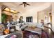 Spacious living room with dark wood floors features a large sofa and bar area, perfect for entertaining at 41503 N 109Th Pl, Scottsdale, AZ 85262