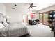 Spacious main bedroom features a ceiling fan, door to a balcony, hardwood floors, neutral decor, and lots of natural light at 41503 N 109Th Pl, Scottsdale, AZ 85262