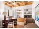 Home office features built-in shelves, wood desk, coffered ceilings, shutters and lots of light for a productive work environment at 41503 N 109Th Pl, Scottsdale, AZ 85262