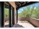 Outdoor patio with a desert view visible from the open sliding glass doors at 41503 N 109Th Pl, Scottsdale, AZ 85262