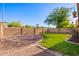 Large backyard with lush grass, brick accents, and a mature tree, ready for outdoor enjoyment at 4515 E Verbena Dr, Phoenix, AZ 85044