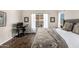 Comfortable bedroom with wood floors, neutral paint, and a bright window view at 4515 E Verbena Dr, Phoenix, AZ 85044