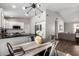 Open-concept dining area with modern light fixture, adjacent to kitchen and living room at 4515 E Verbena Dr, Phoenix, AZ 85044