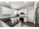 Updated kitchen featuring white cabinets, dark countertops, and stainless steel appliances at 4515 E Verbena Dr, Phoenix, AZ 85044
