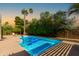 Refreshing backyard pool with ample patio space, lush greenery, and mature trees offering shade at 5333 E Sheena Dr, Scottsdale, AZ 85254