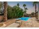 Backyard with pool, mature landscaping, lounge chairs, diving board, and outdoor seating at 5333 E Sheena Dr, Scottsdale, AZ 85254