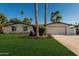 Inviting home featuring a well-kept lawn, driveway, desert landscaping, and a two-car garage at 5333 E Sheena Dr, Scottsdale, AZ 85254