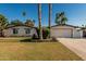 Charming single-story home with a well-maintained front yard and driveway, complemented by mature trees and landscaping at 5333 E Sheena Dr, Scottsdale, AZ 85254