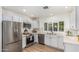 Modern kitchen with white cabinets, stainless steel appliances, and stylish fixtures and fittings at 5333 E Sheena Dr, Scottsdale, AZ 85254