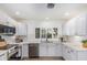 Bright kitchen boasts white cabinets, stainless steel appliances, and a garden window at 5333 E Sheena Dr, Scottsdale, AZ 85254