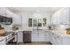 Updated kitchen with white cabinets, stainless steel appliances, tile backsplash, and a large window at 5333 E Sheena Dr, Scottsdale, AZ 85254