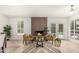 Bright living room with modern fireplace, stylish seating, and French doors to the backyard pool at 5333 E Sheena Dr, Scottsdale, AZ 85254