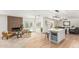 Open-concept living space featuring a fireplace, kitchen with island, and access to the pool area at 5333 E Sheena Dr, Scottsdale, AZ 85254