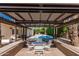 Inviting outdoor patio area featuring a pergola and a refreshing pool view. The perfect spot for relaxation and entertainment at 5333 E Sheena Dr, Scottsdale, AZ 85254