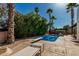 Private backyard oasis with a sparkling pool, diving board, and lounge chairs at 5333 E Sheena Dr, Scottsdale, AZ 85254