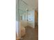 Bathroom shower with glass doors, dual shower head, bench, and gray tile floor at 5455 E Lincoln Dr # 1004, Paradise Valley, AZ 85253
