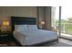 Luxurious bedroom featuring a king-size bed, modern furnishings, and a private outdoor balcony at 5455 E Lincoln Dr # 1004, Paradise Valley, AZ 85253