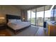 Stylish bedroom with a king bed, large windows offering natural light, and modern decor at 5455 E Lincoln Dr # 1004, Paradise Valley, AZ 85253