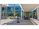 Modern building entrance with palm trees, bench seating and contemporary design at 5455 E Lincoln Dr # 1004, Paradise Valley, AZ 85253