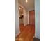 A hallway showcases a wooden closet with shelves and hanging space, complemented by sleek wood flooring and ample lighting at 5455 E Lincoln Dr # 1004, Paradise Valley, AZ 85253