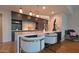 Stylish kitchen includes a large island with seating, modern pendant lights, and stainless appliances at 5455 E Lincoln Dr # 1004, Paradise Valley, AZ 85253