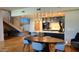 Modern kitchen with stone countertops, stainless steel appliances, pendant lighting, and open staircase at 5455 E Lincoln Dr # 1004, Paradise Valley, AZ 85253