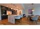 Elegant kitchen with a large island, pendant lighting, modern bar stools, and open layout to living area at 5455 E Lincoln Dr # 1004, Paradise Valley, AZ 85253