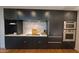 Modern kitchen showcases sleek black cabinetry, stainless steel appliances, and marble backsplash at 5455 E Lincoln Dr # 1004, Paradise Valley, AZ 85253