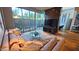 Bright living room featuring plush sofa, glass coffee table, floor-to-ceiling windows, and stylish decor at 5455 E Lincoln Dr # 1004, Paradise Valley, AZ 85253