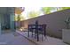 Inviting outdoor patio with a modern dining set, stylish pavers, and privacy landscaping at 5455 E Lincoln Dr # 1004, Paradise Valley, AZ 85253