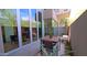 Cozy outdoor patio featuring a dining set, stone accents, and easy access to indoor living spaces at 5455 E Lincoln Dr # 1004, Paradise Valley, AZ 85253