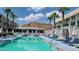 A luxurious pool area boasts comfortable lounge chairs and umbrellas, set against a backdrop of scenic mountain views at 5455 E Lincoln Dr # 1004, Paradise Valley, AZ 85253