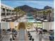 Luxurious pool area featuring modern design, cabanas, lounge chairs and scenic mountain views at 5455 E Lincoln Dr # 1004, Paradise Valley, AZ 85253