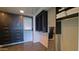 Large walk-in closet with custom dark wood cabinets and drawers for optimal organization at 5455 E Lincoln Dr # 1004, Paradise Valley, AZ 85253