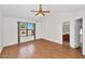 Bright bedroom with vaulted ceiling, wood floors, window views, and access to an ensuite bath at 5860 W Saragosa St, Chandler, AZ 85226