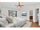 Staged bedroom with vaulted ceiling, wood floors, window views, and access to an ensuite bath at 5860 W Saragosa St, Chandler, AZ 85226