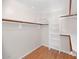 Walk-in closet featuring laminate floors, built-in shelves, and ample storage space at 5860 W Saragosa St, Chandler, AZ 85226