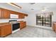 Bright kitchen with tile floors, wood cabinets, modern appliances, and a window overlooking the yard at 5860 W Saragosa St, Chandler, AZ 85226