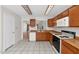 Cozy kitchen featuring tile floors, wood cabinets, modern appliances, and white dishwasher at 5860 W Saragosa St, Chandler, AZ 85226