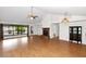Open-concept living room boasts wood floors, a brick fireplace, and lots of natural light at 5860 W Saragosa St, Chandler, AZ 85226
