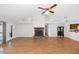 Spacious living room features wood floors, a brick fireplace, and patio access at 5860 W Saragosa St, Chandler, AZ 85226