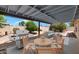 Outdoor patio space featuring a seating area, grill, concrete floor, and desert-style yard at 5860 W Saragosa St, Chandler, AZ 85226